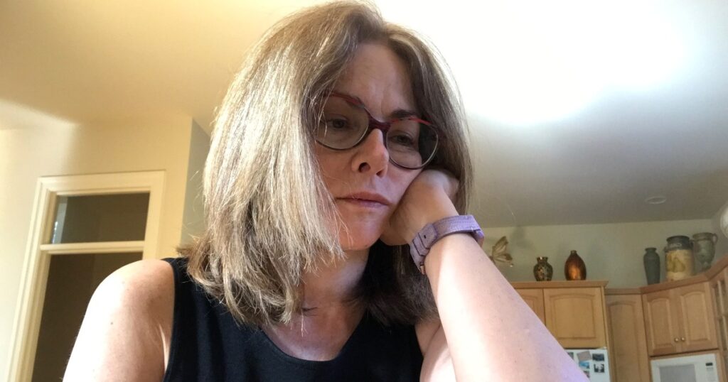 Woman sitting alone feeling emotionally exhausted after betrayal trauma and infidelity