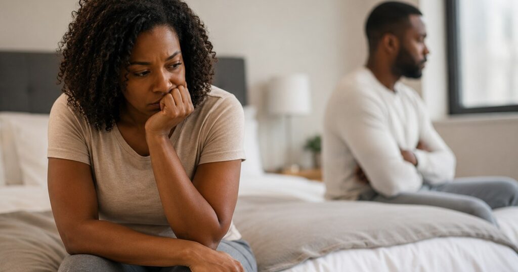 Wife feeling troubled while emotionally distant husband sits nearby during suspected infidelity